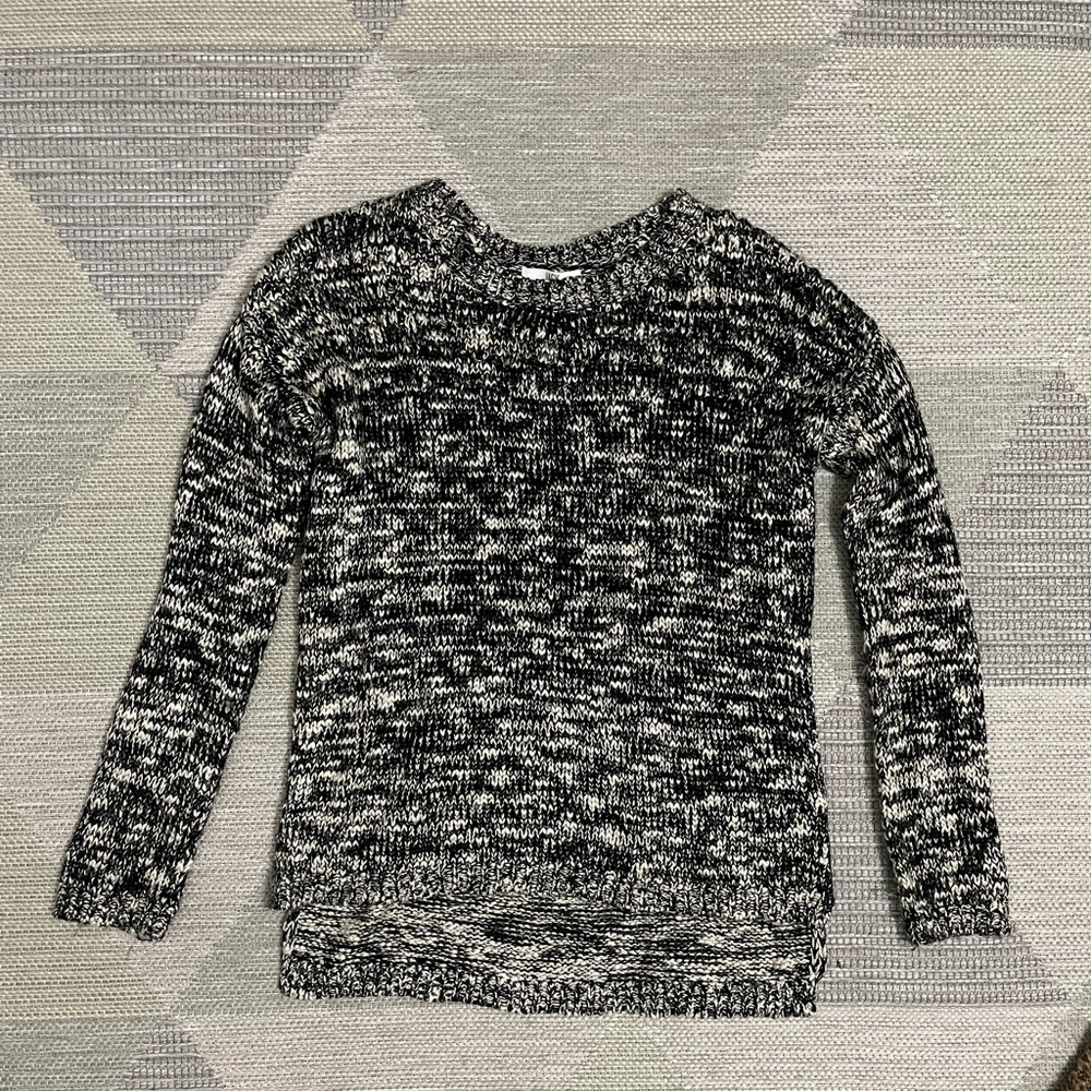Black and white knit sweater with subtle gold thread